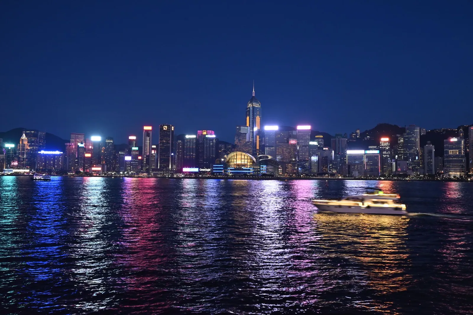 A night view of Hong Kong's illuminated skyline reflecting on Victoria Harbour