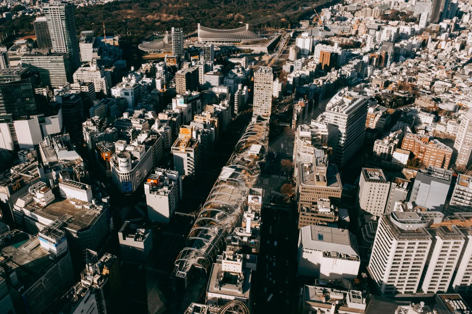 Aerial view of Tokyo, Japan, showing dense urban architecture under bright sunlight