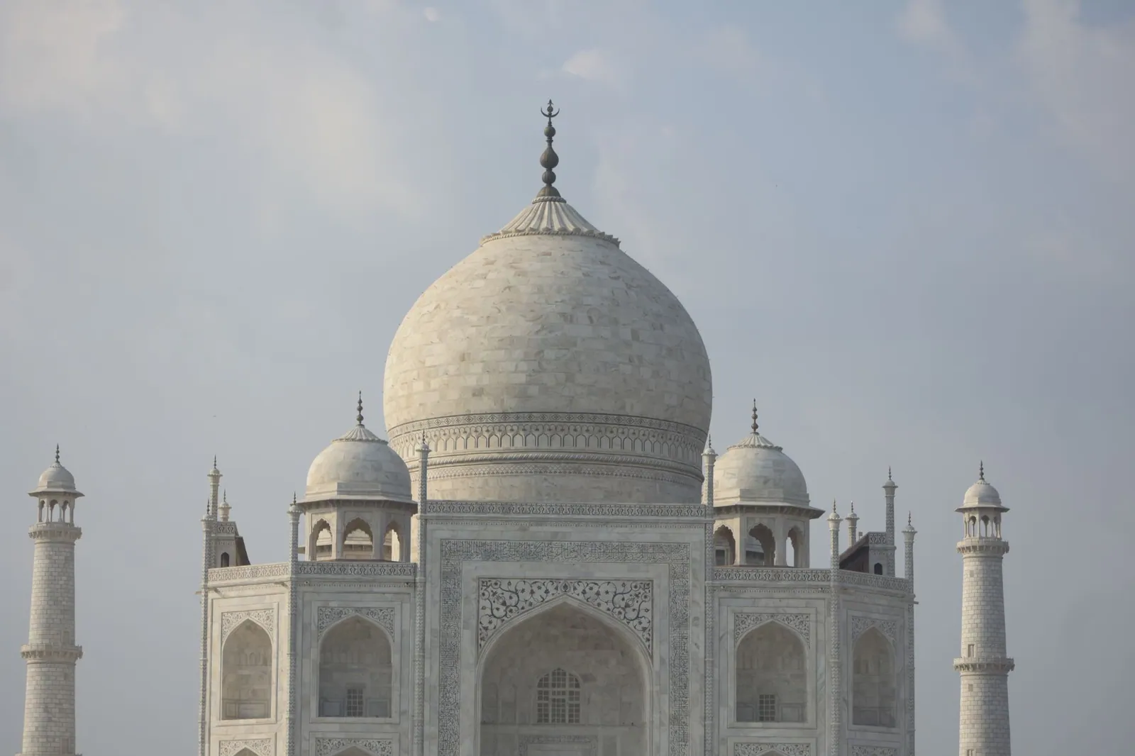 A stunning view of the Taj Mahal's marble dome showcasing Mughal architecture in Agra, India