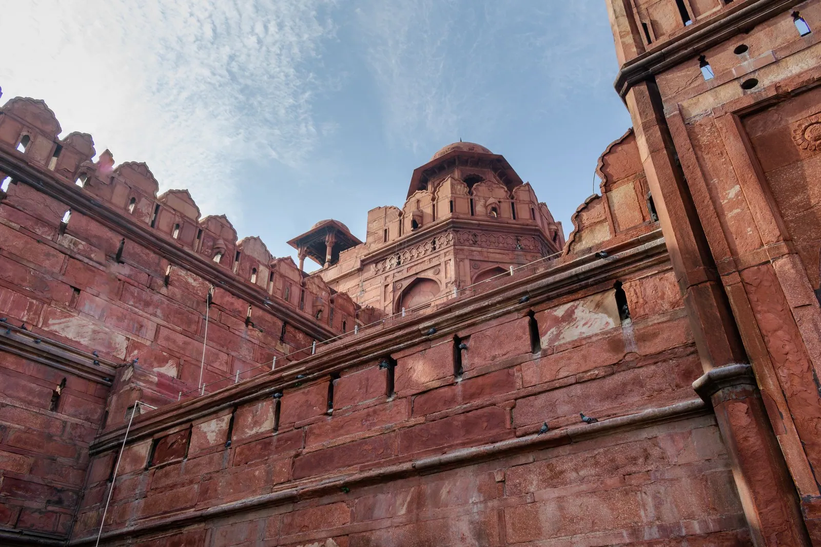 Low-angle view of the Red Fort's historic Mughal architecture in Delhi, India