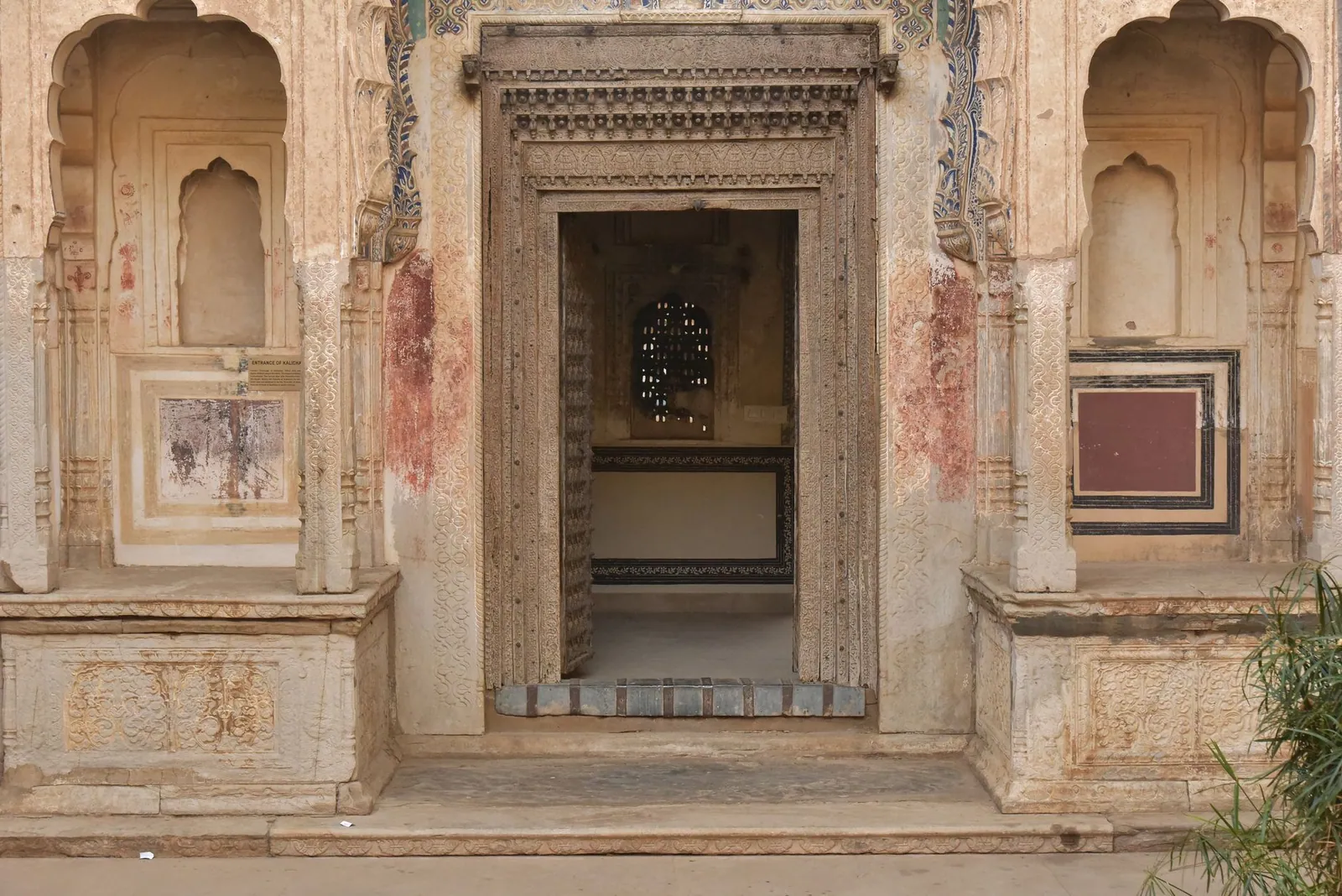 Intricate Rajasthani architectural entrance with ornate stonework in Jaipur, India