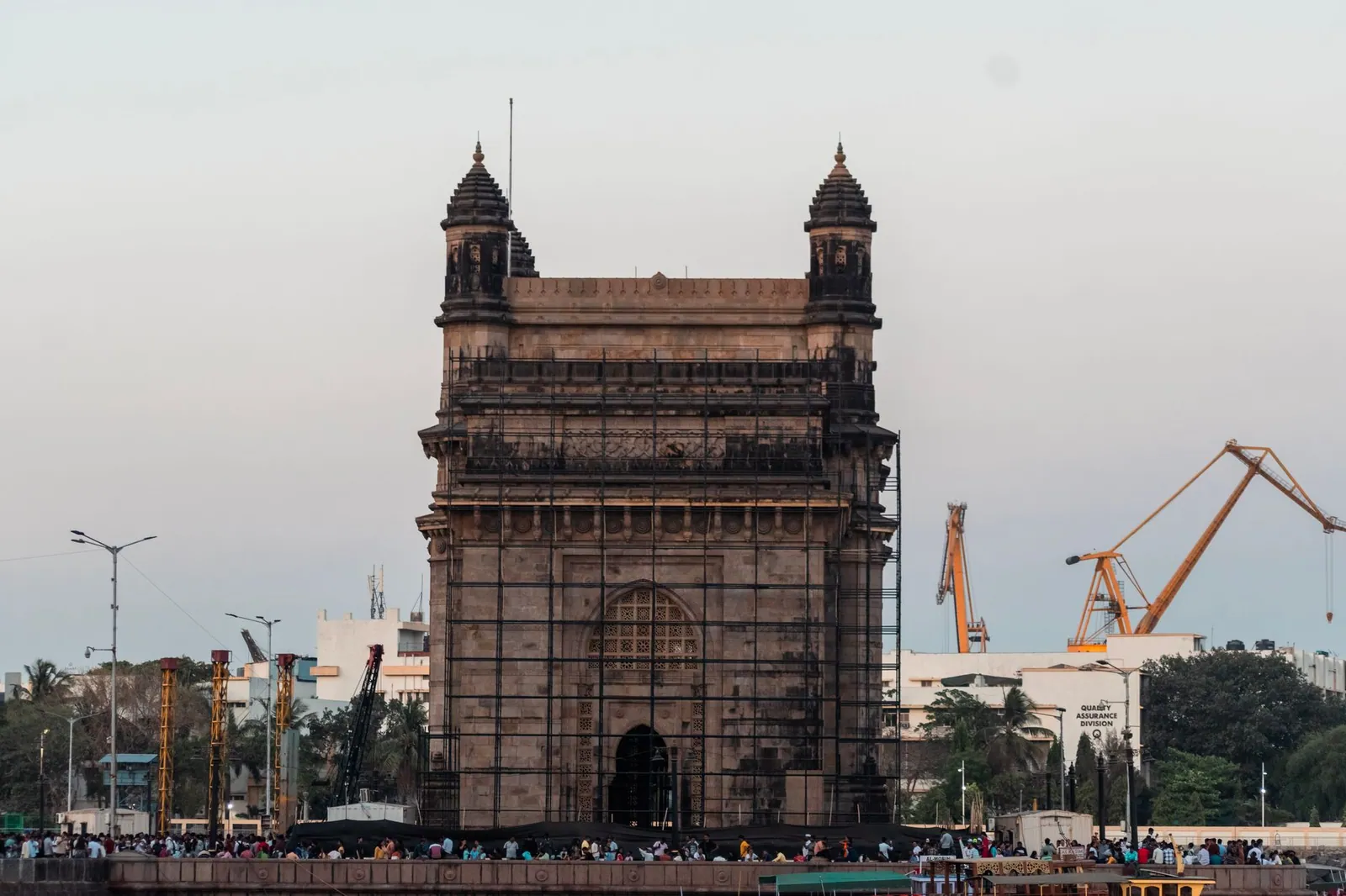 Iconic Gateway of India monument in Mumbai, a popular tourist attraction, captured at dusk.