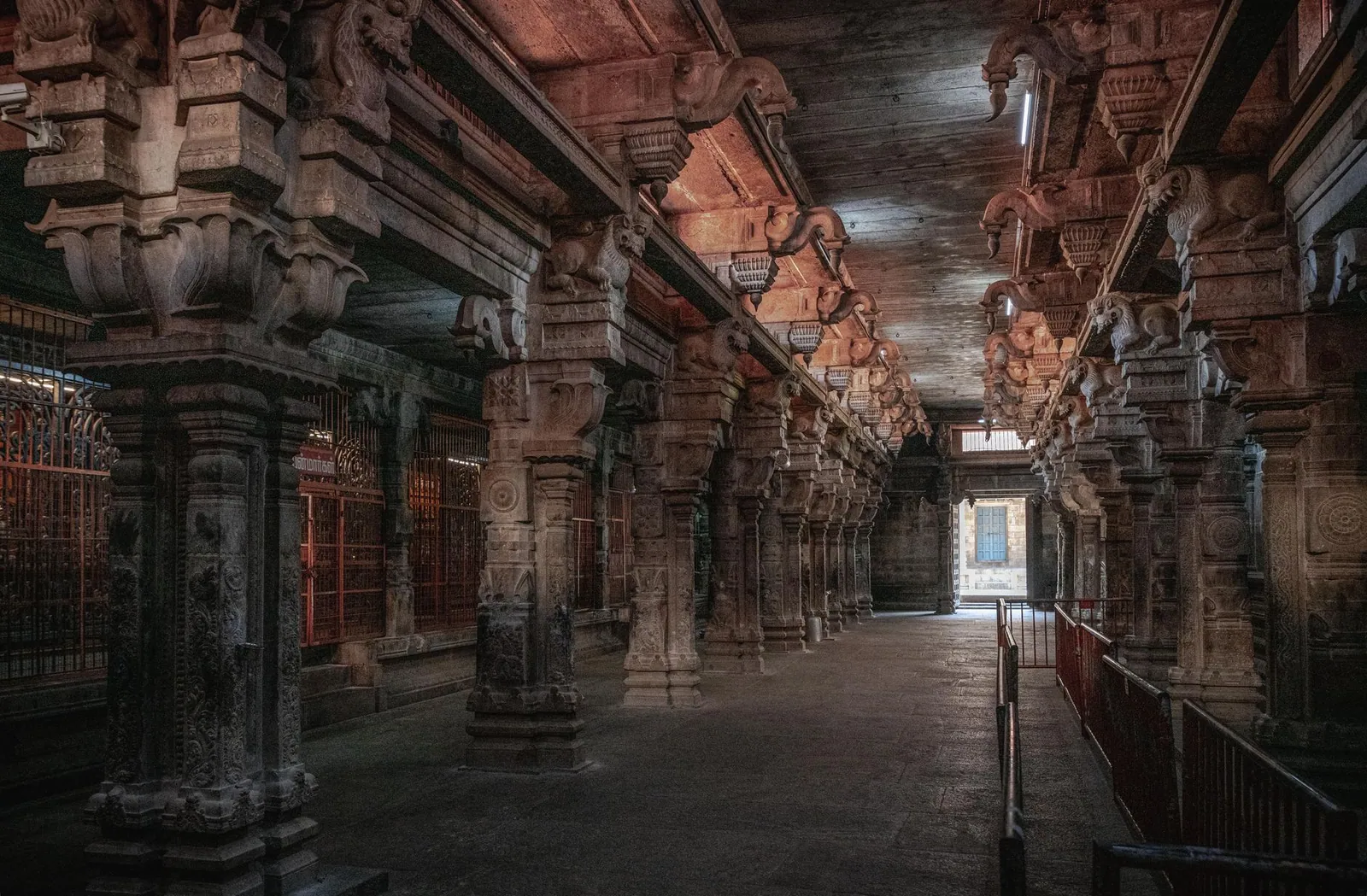Explore the ancient stone architecture and intricate carvings of a temple in Tiruchirappalli, India.