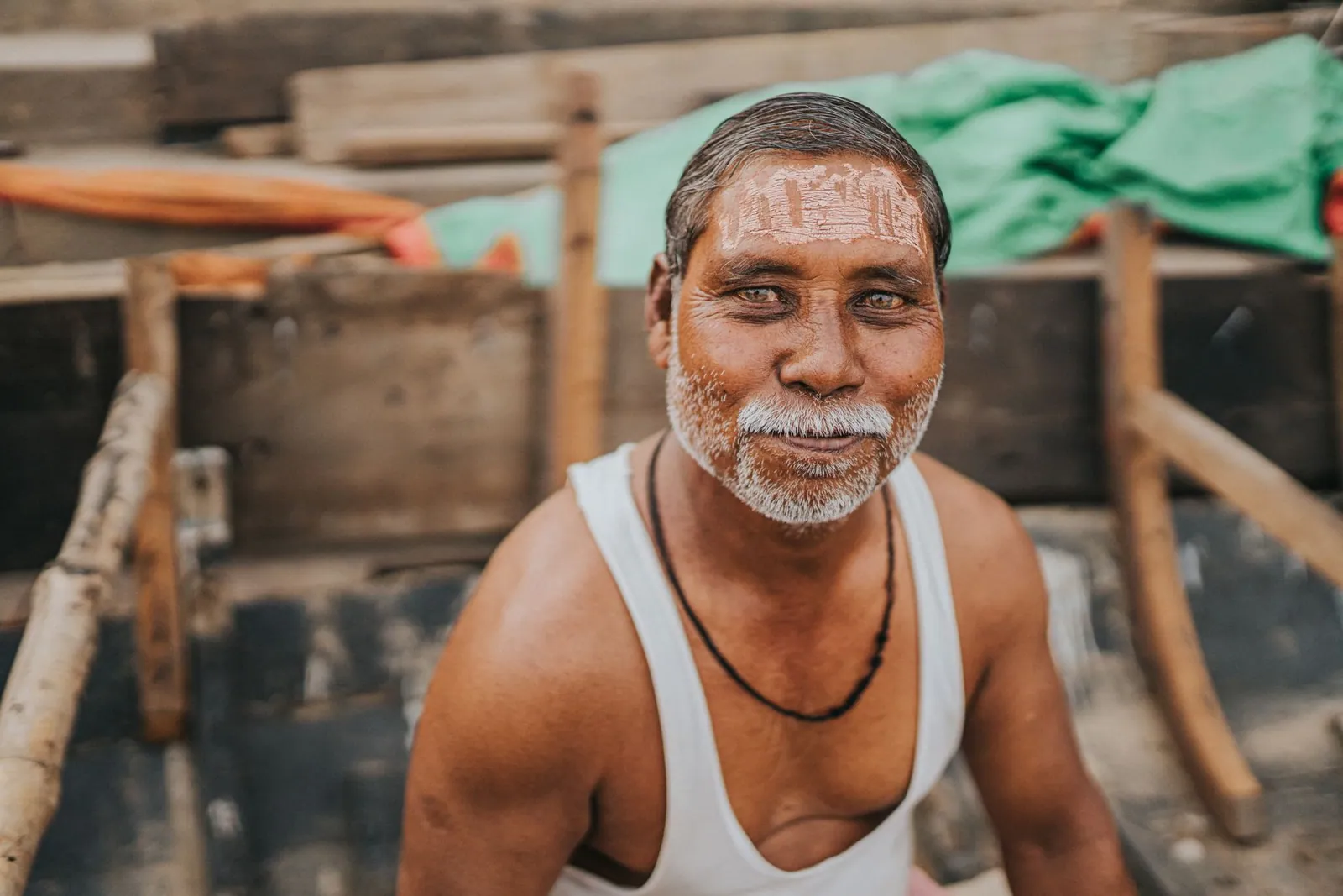 Portrait of a smiling man in a traditional boat in Varanasi, India