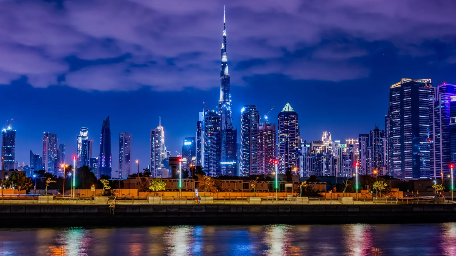 Night view of Dubai's skyline featuring the illuminated Burj Khalifa