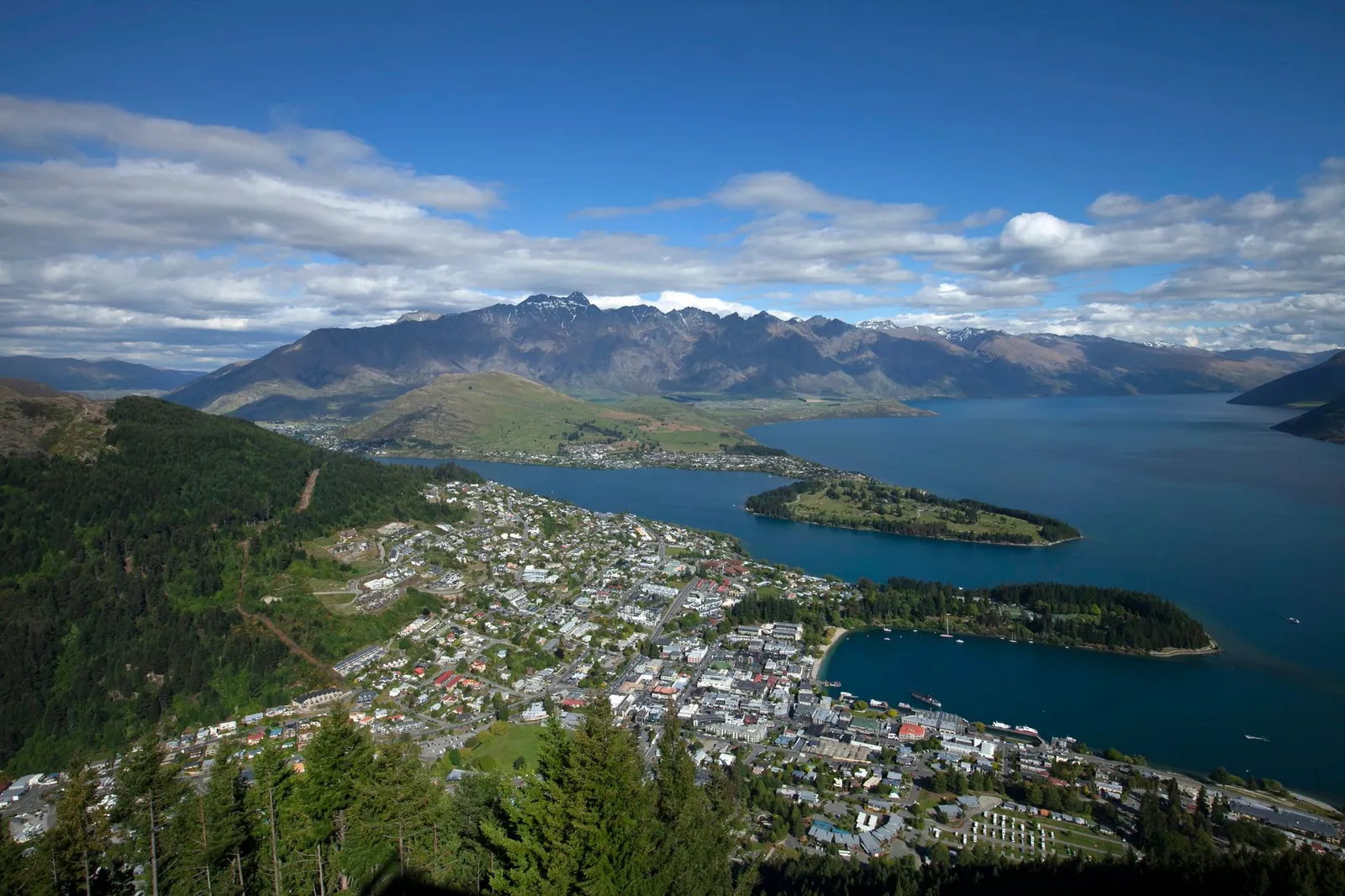 An aerial view of Queenstown, New Zealand, overlooking Lake Wakatipu and the mountains