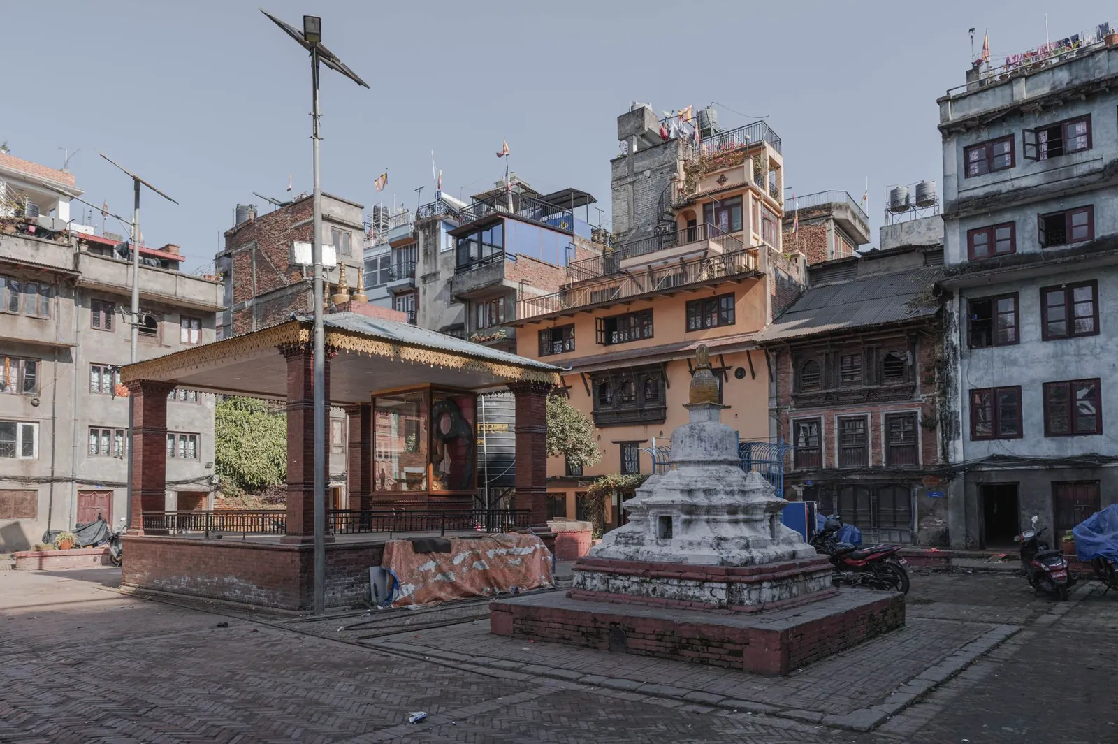 Square in Kathmandu featuring a stupa and traditional Nepali architecture