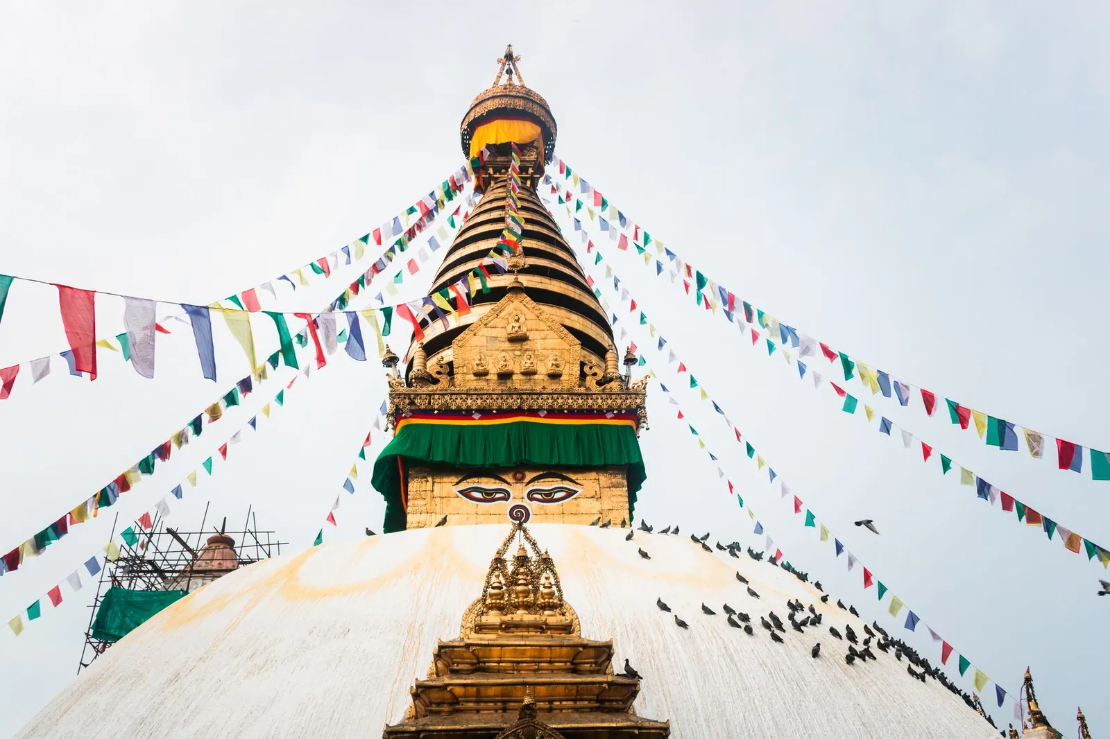 Vibrant prayer flags surround the iconic Swayambhunath Stupa in Kathmandu, Nepal