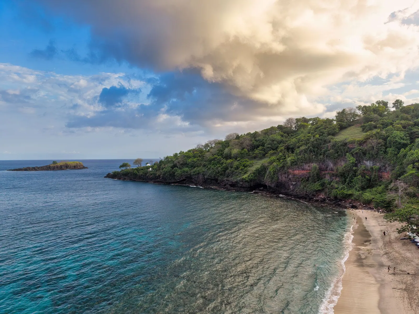 Breathtaking aerial shot of a tranquil beach and lush greenery in Bali, Indonesia