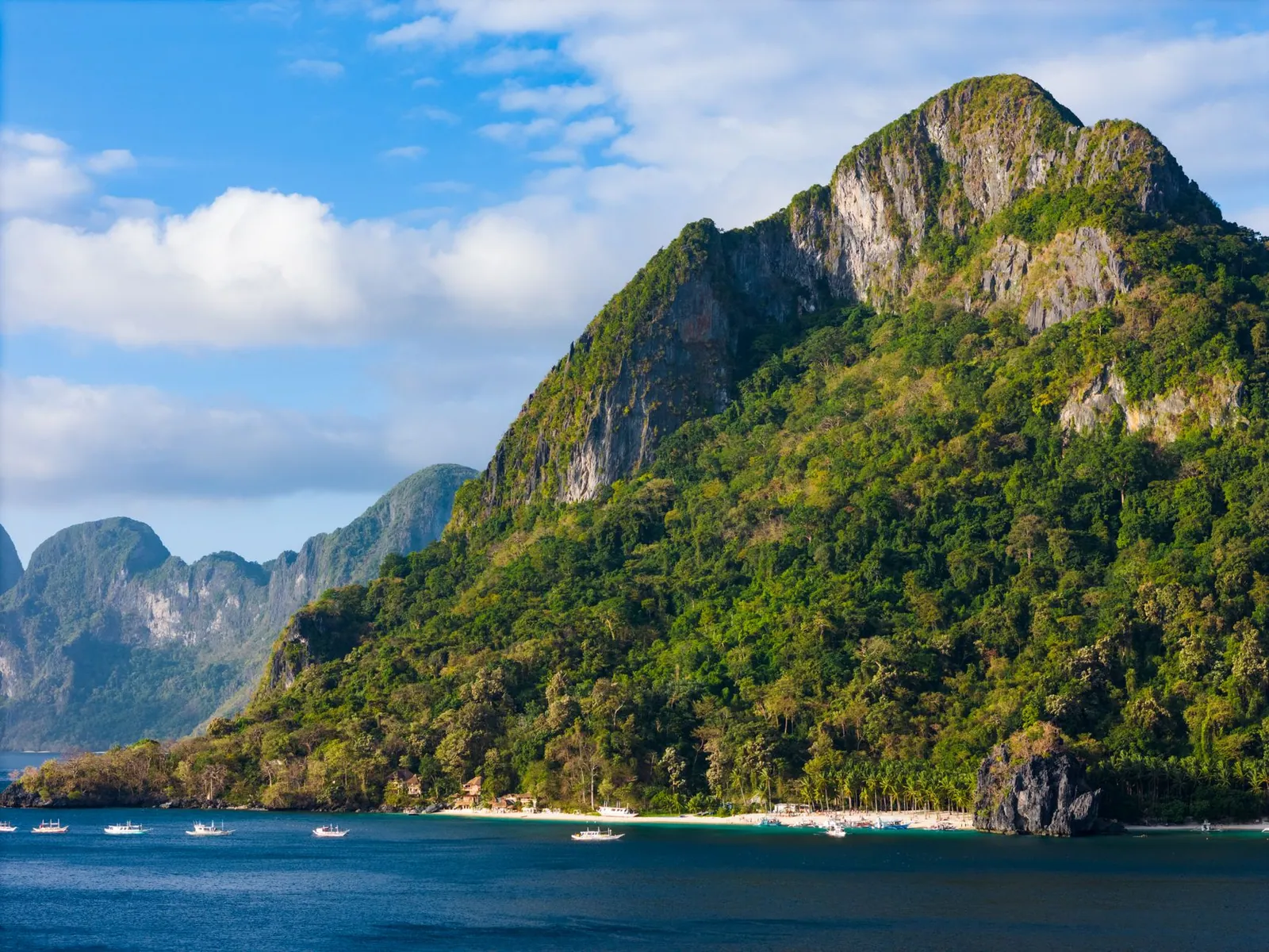 El Nido's karst landscape with lush greenery and blue seas in Palawan, Philippines