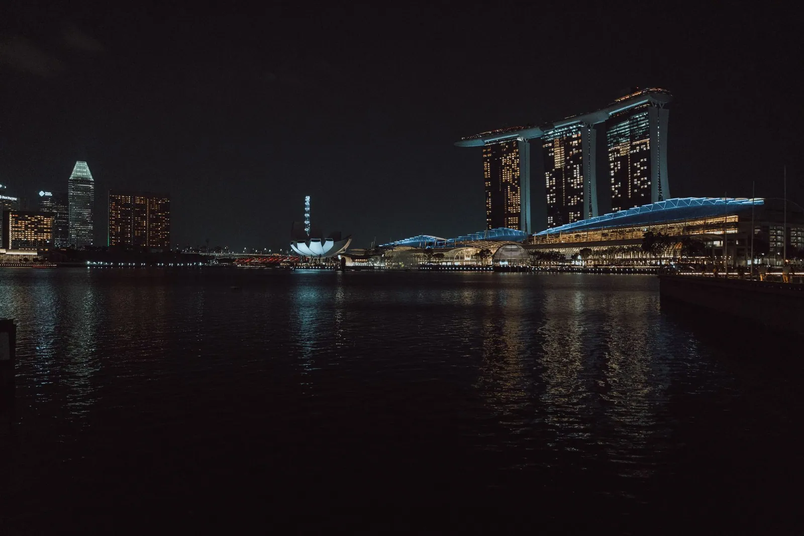 Captivating night view of Singapore skyline featuring Marina Bay Sands and cityscape reflections.