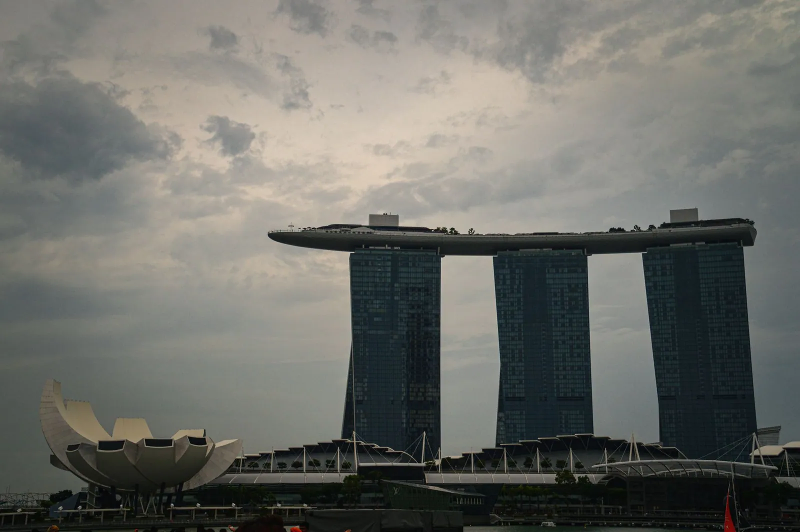 Dramatic view of Marina Bay Sands and ArtScience Museum under cloudy skies in Singapore