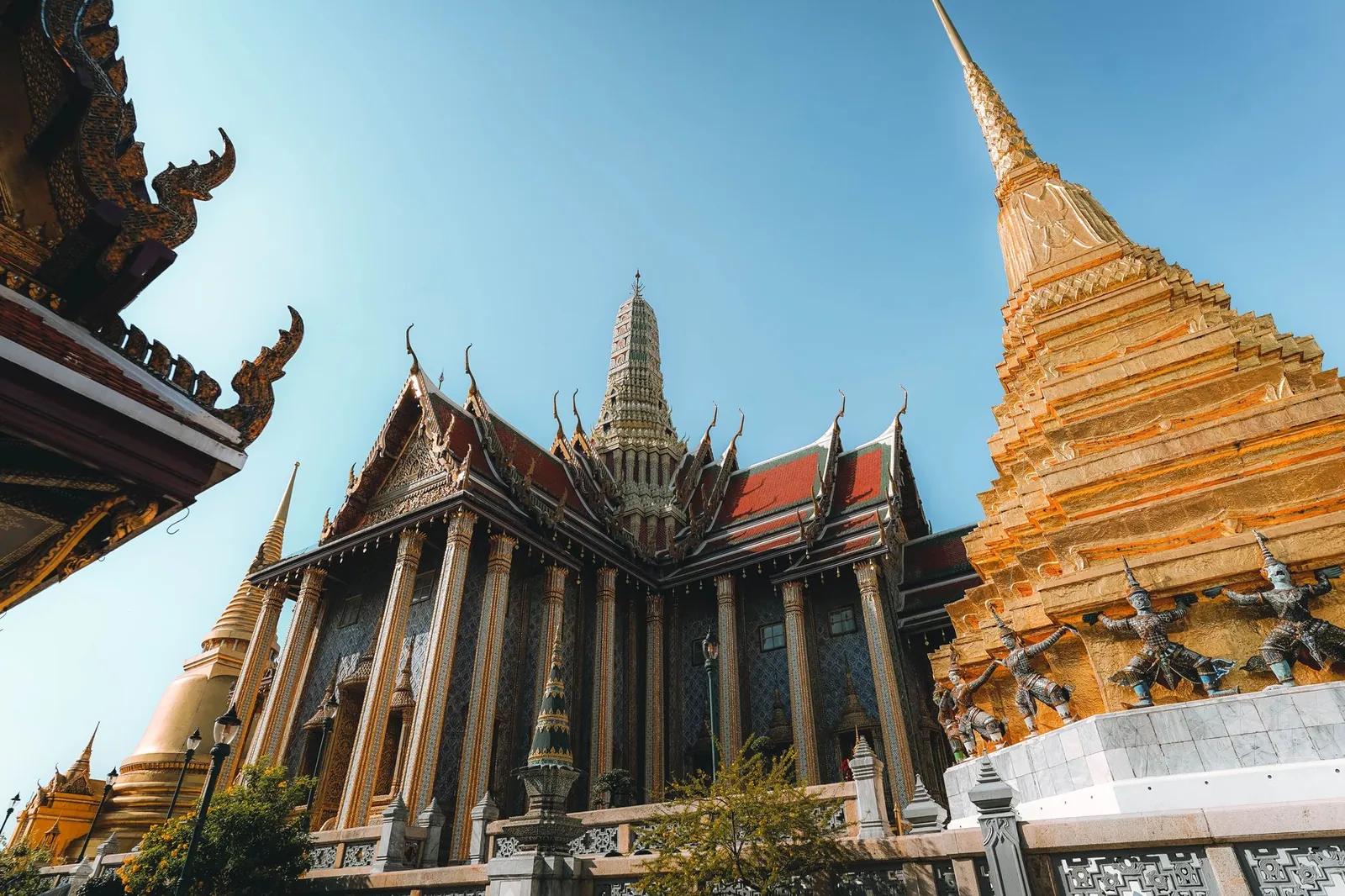 The Grand Palace temple's intricate architecture and golden pagoda in Bangkok, Thailand