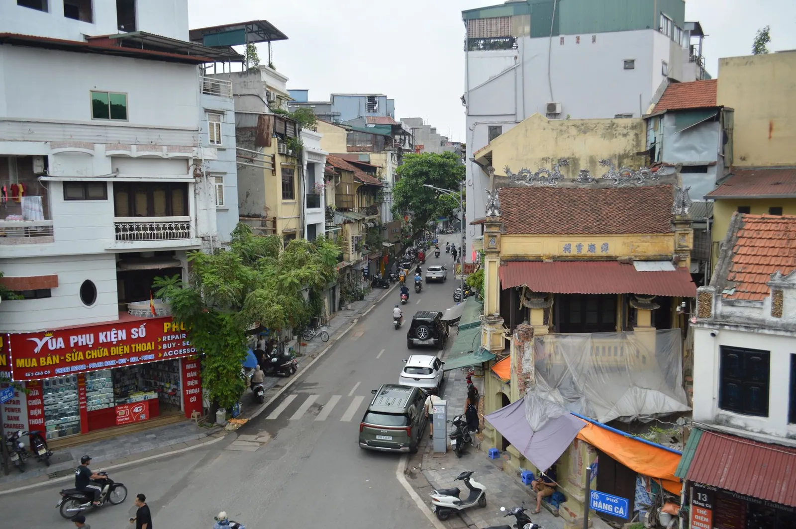 A busy street in Hanoi, Vietnam, showing local architecture and city life