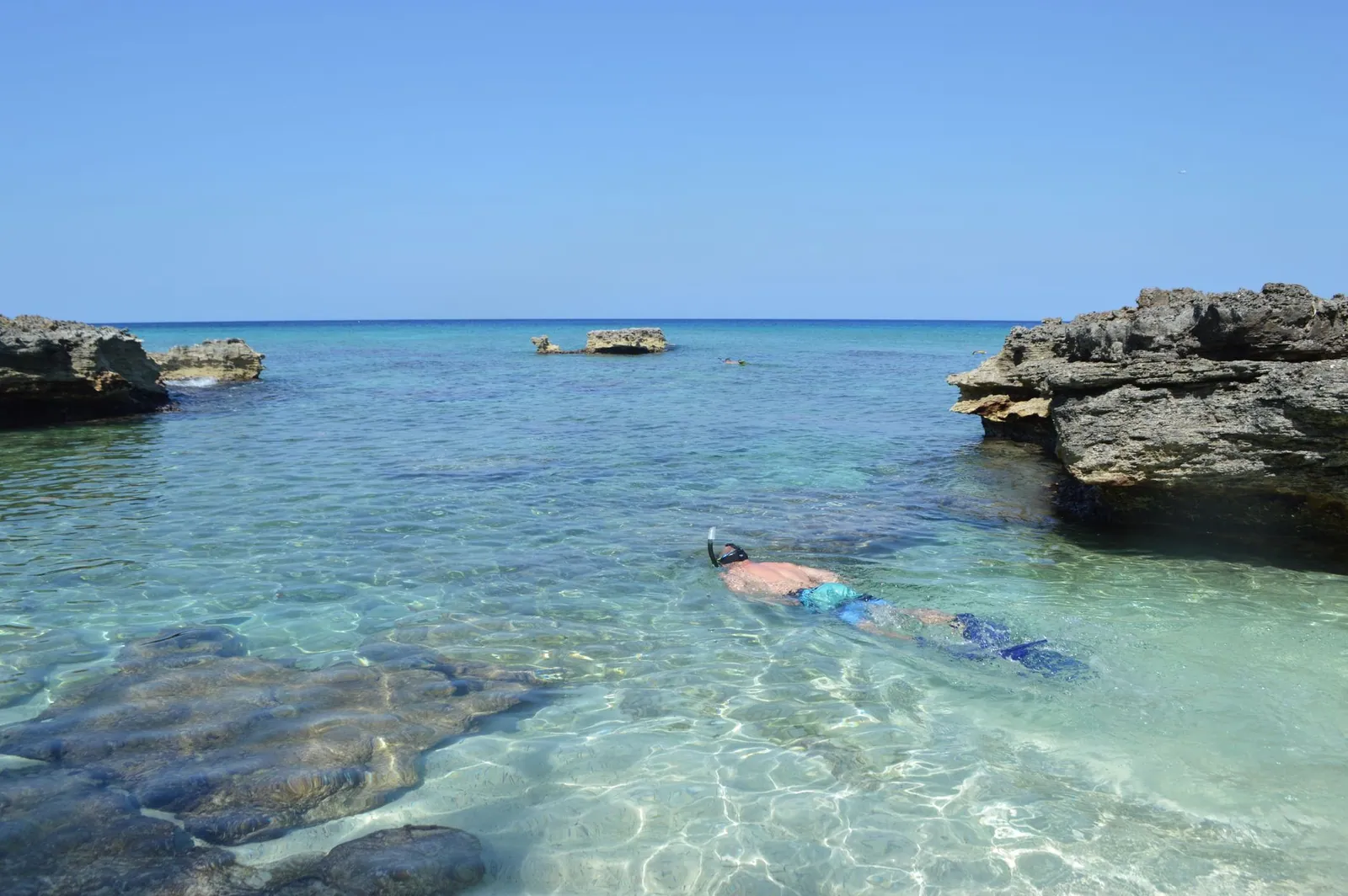 A traveller snorkelling in crystal clear tropical water