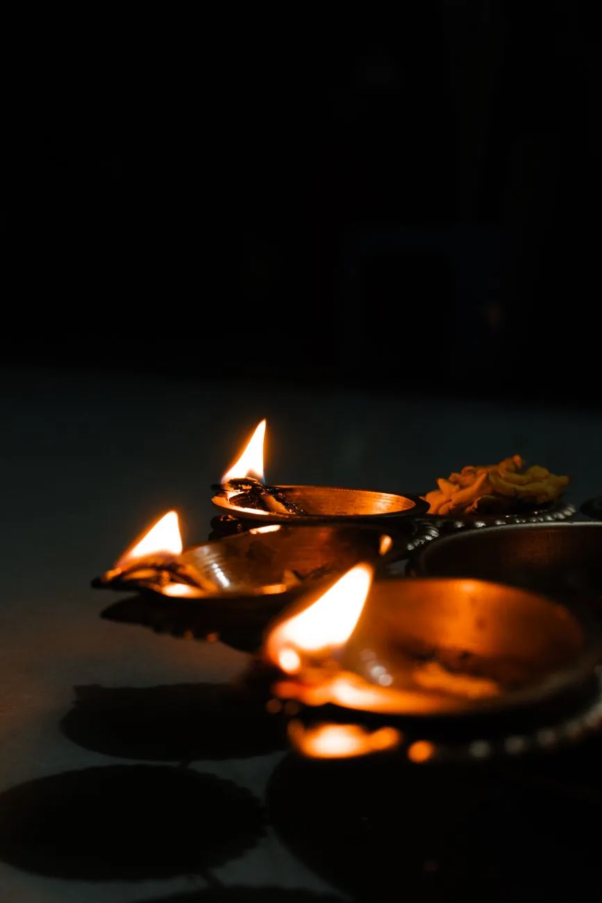 Close-up of traditional Diwali oil lamps with glowing flames, symbolising the Festival of Lights in India