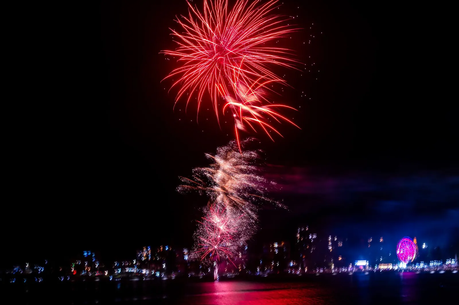 Fireworks lighting up the night sky over the water