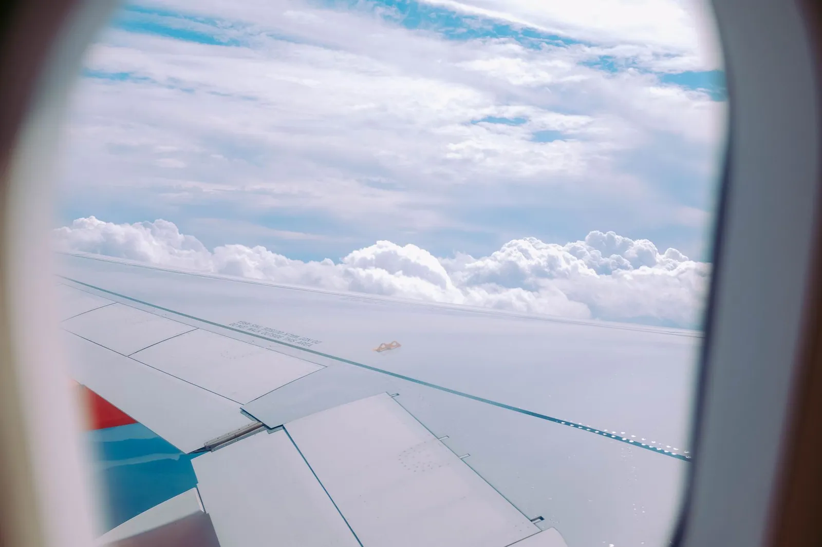 Serene view of fluffy clouds through a cabin window, capturing the essence of travel